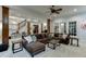 Expansive basement with sectional sofa, multiple seating areas, and stairs to upper level at 879 Big Horn Hollow, Suwanee, GA 30024