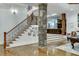 Elegant basement staircase with wrought iron railing and stone pillars at 879 Big Horn Hollow, Suwanee, GA 30024