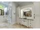 Elegant bathroom with custom cabinetry, vanity, and a view of the walk-in shower at 879 Big Horn Hollow, Suwanee, GA 30024