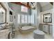 Primary bathroom with soaking tub, double vanity, and large mirror at 879 Big Horn Hollow, Suwanee, GA 30024