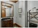 Modern bathroom with dark vanity, large mirror, and industrial shelving at 879 Big Horn Hollow, Suwanee, GA 30024