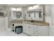 Bathroom with white vanity, double sinks, and a large mirror at 879 Big Horn Hollow, Suwanee, GA 30024