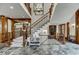 Two-story entryway with a grand staircase and chandelier at 879 Big Horn Hollow, Suwanee, GA 30024