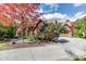 Brick home with a large driveway and beautiful landscaping at 879 Big Horn Hollow, Suwanee, GA 30024