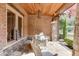 Brick front porch with a swing and stone flooring at 879 Big Horn Hollow, Suwanee, GA 30024