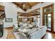Gathering room features a large sectional sofa, fireplace and open kitchen at 879 Big Horn Hollow, Suwanee, GA 30024