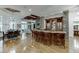Large home bar with granite countertop, wooden cabinets, and leather barstools at 879 Big Horn Hollow, Suwanee, GA 30024