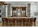 Elegant home bar with stone accents and leather barstools at 879 Big Horn Hollow, Suwanee, GA 30024