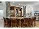 Custom-built home bar with stone accents and leather barstools at 879 Big Horn Hollow, Suwanee, GA 30024