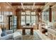 Luxurious home office with wood paneled walls, built-in shelving, and large windows at 879 Big Horn Hollow, Suwanee, GA 30024