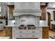 Luxury kitchen with professional range, custom cabinetry, and granite counters at 879 Big Horn Hollow, Suwanee, GA 30024