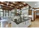 Spacious kitchen boasts double islands, granite counters, and wood beams at 879 Big Horn Hollow, Suwanee, GA 30024