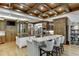 Open kitchen with two islands, granite counters, and wooden ceiling beams at 879 Big Horn Hollow, Suwanee, GA 30024