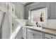 Bright laundry room featuring a sink with granite countertop and ample cabinet space at 879 Big Horn Hollow, Suwanee, GA 30024