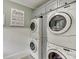 Laundry room with stackable washer and dryer at 879 Big Horn Hollow, Suwanee, GA 30024