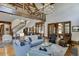 Two-story living room with hardwood floors, staircase, and large windows at 879 Big Horn Hollow, Suwanee, GA 30024
