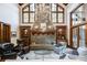 Spacious living room with stone fireplace, high ceilings, and large windows at 879 Big Horn Hollow, Suwanee, GA 30024