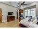 Main bedroom with fireplace, TV, and built-in shelving at 879 Big Horn Hollow, Suwanee, GA 30024