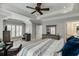 Main bedroom with wood-paneled feature wall and sitting area at 879 Big Horn Hollow, Suwanee, GA 30024