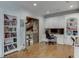 Home office with built-in shelving and a view of a stone accent wall at 879 Big Horn Hollow, Suwanee, GA 30024