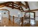 Open loft area with hardwood floors and exposed wooden beams at 879 Big Horn Hollow, Suwanee, GA 30024
