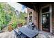 Brick patio with outdoor dining area, grill, and wooded views at 879 Big Horn Hollow, Suwanee, GA 30024