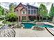 Stunning kidney shaped pool with flagstone patio and lush landscaping at 879 Big Horn Hollow, Suwanee, GA 30024