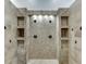 Large walk-in shower with multiple shower heads and built-in shelving at 879 Big Horn Hollow, Suwanee, GA 30024