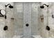 Double shower with pebble tile accents and rainfall shower heads at 879 Big Horn Hollow, Suwanee, GA 30024