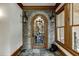 Wine cellar with stone archway, glass door, and slate tile floor at 879 Big Horn Hollow, Suwanee, GA 30024