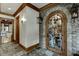 Elegant wine cellar with stone accents and extensive wooden racking at 879 Big Horn Hollow, Suwanee, GA 30024