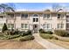 Condo exterior with gray siding, arched window, and green landscaping at 1538 Chantilly Ne Dr # 224, Atlanta, GA 30324