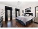 Bedroom with black and white decor and hardwood floors at 703 Hammond Dr, Woodstock, GA 30188
