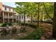 Charming courtyard with fire pit, seating area and lush landscaping at 703 Hammond Dr, Woodstock, GA 30188