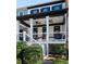 Two story home with front porch and landscaping at 703 Hammond Dr, Woodstock, GA 30188