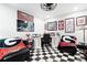Stylish home office features a checkerboard floor, comfortable seating, and built-in desk at 703 Hammond Dr, Woodstock, GA 30188
