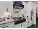 Modern kitchen with granite countertops, white cabinets, and a gas cooktop at 703 Hammond Dr, Woodstock, GA 30188