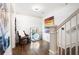 Bright landing area with hardwood floors, a comfortable chair, and elegant wall art at 703 Hammond Dr, Woodstock, GA 30188