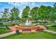 Scenic park featuring a charming water fountain, benches, and lush landscaping, ideal for relaxation and recreation at 703 Hammond Dr, Woodstock, GA 30188