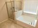 This bathroom has a separate tub and shower, with a bright window at 3978 Lake Manor Way, Atlanta, GA 30349