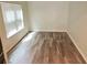 Bedroom with light walls, hardwood floors, and natural light at 3978 Lake Manor Way, Atlanta, GA 30349