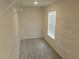 This walk-in closet features carpeted floors, built-in shelving, and natural light from the window at 3978 Lake Manor Way, Atlanta, GA 30349