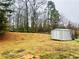 Large backyard with a shed and natural surroundings at 2717 Kristen Ct, Conyers, GA 30012
