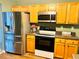 Modern kitchen featuring stainless steel appliances, granite counters, and updated cabinets at 2717 Kristen Ct, Conyers, GA 30012
