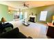 Spacious living room featuring a fireplace, plush carpeting, and abundant natural light at 2717 Kristen Ct, Conyers, GA 30012