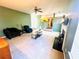 Bright living room with fireplace, neutral carpet, ceiling fan, and view into the kitchen at 2717 Kristen Ct, Conyers, GA 30012