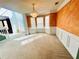 Spacious living room with elegant chandelier, large windows, and neutral carpeting at 2717 Kristen Ct, Conyers, GA 30012