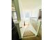 Inviting staircase leading to the main level with a grand window and natural lighting at 2717 Kristen Ct, Conyers, GA 30012