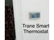 Close up of Trane smart thermostat used to control the house temperature at 2717 Kristen Ct, Conyers, GA 30012