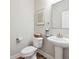 Elegant half bathroom with modern fixtures, pedestal sink, and stylish decor, enhancing the home's appeal at 802 Oak Promenade Ln, Canton, GA 30115